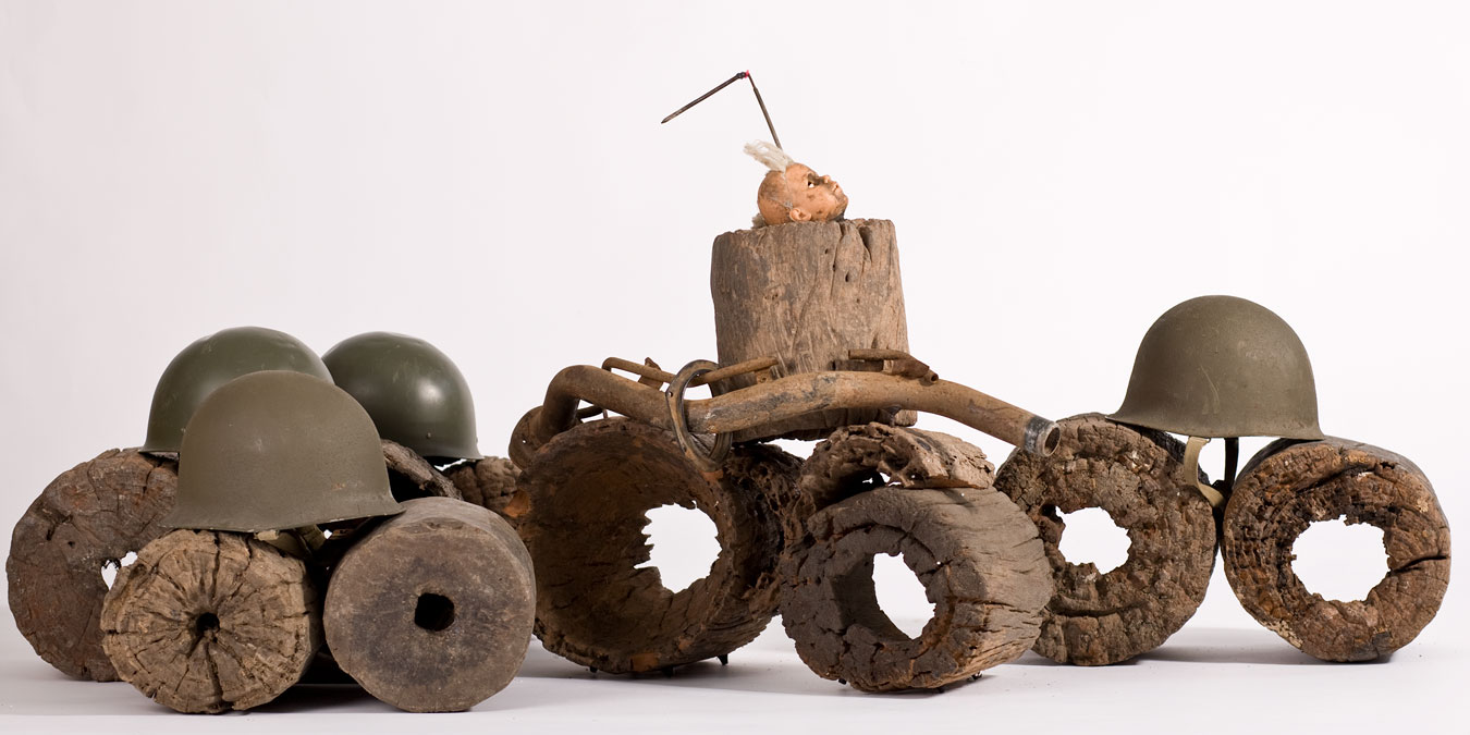 Gérard Quenum, Dictateur (detail), 2012. Wood, doll, antenna, metal pipe and helmets, 78 x 105 x 637 cm