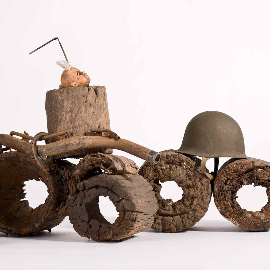 Gérard Quenum, Dictateur (detail), 2012. Wood, doll, antenna, metal pipe and helmets, 78 x 105 x 637 cm