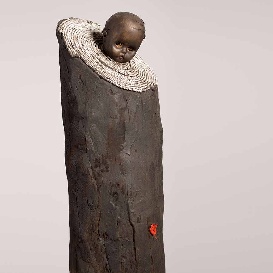 Gérard Quenum, La bonne bergère (The Good Sheperdess), 2012. Wood, metal, beads and plastic doll, 169 x 56 x 28 cm.